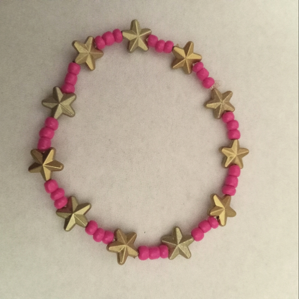 Hand crafted Neon pink bracelet with gold stars